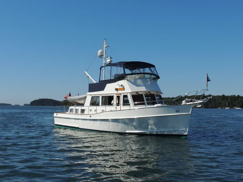 Slide: The Image of 2002 Grand Banks 42 Classic yacht on calm water under clear blue sky. - 9