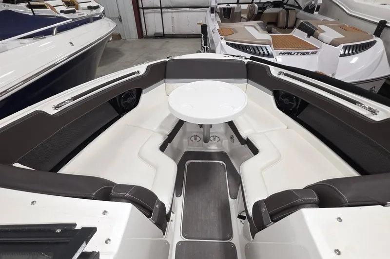 Slide: The Image of 2017 Sea Ray SLX 280 boat interior with seating and table in showroom. - 2
