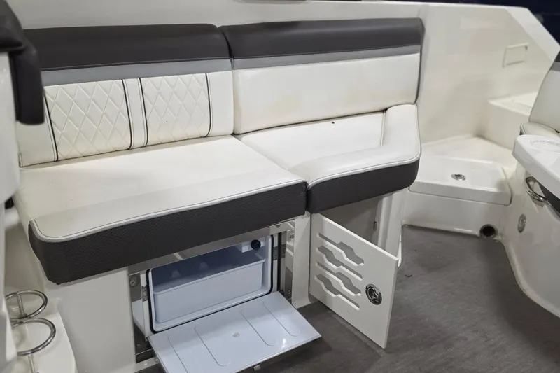 Slide: The Image of 2017 Sea Ray SLX 280 interior with white seating and built-in storage compartment. - 9