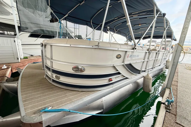 Slide: The Image of 2007 South Bay 925CR TT I/O pontoon boat docked with blue canopy. - 13