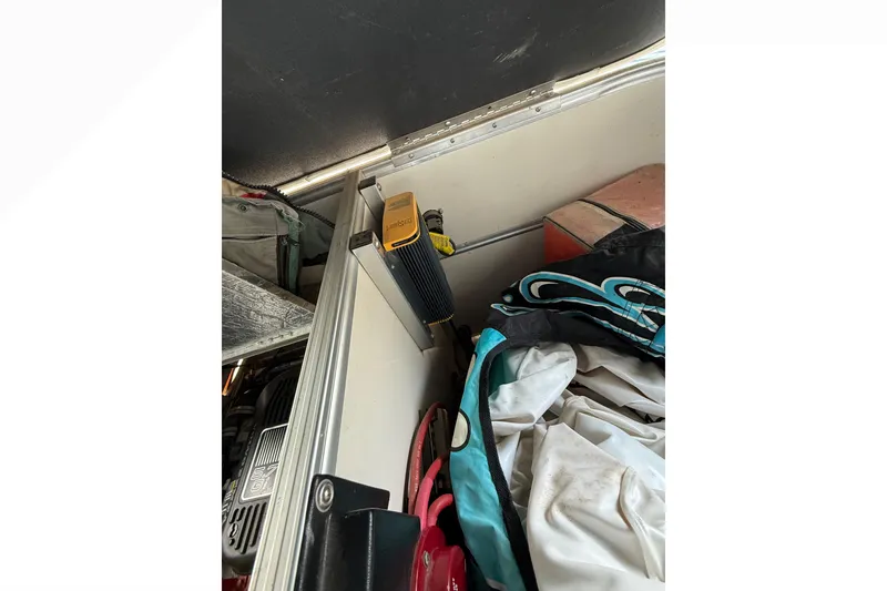 Slide: The Image of Storage compartment in 2007 South Bay 925CR TT I/O boat with various equipment. - 21