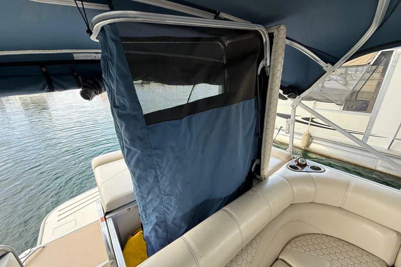 Slide: The Image of 2007 South Bay 925CR TT I/O boat interior with blue privacy curtain and seating. - 24