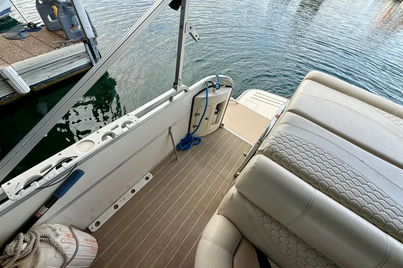 Slide: The Image of 2007 South Bay 925CR TT I/O boat interior with seating and dock view. - 25