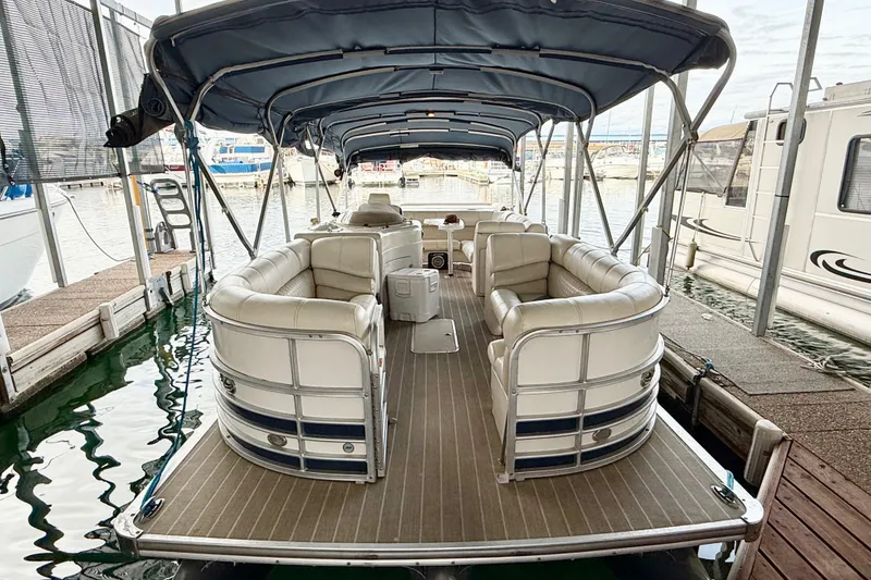Slide: The Image of 2007 South Bay 925CR TT I/O pontoon boat with covered seating at a marina. - 3