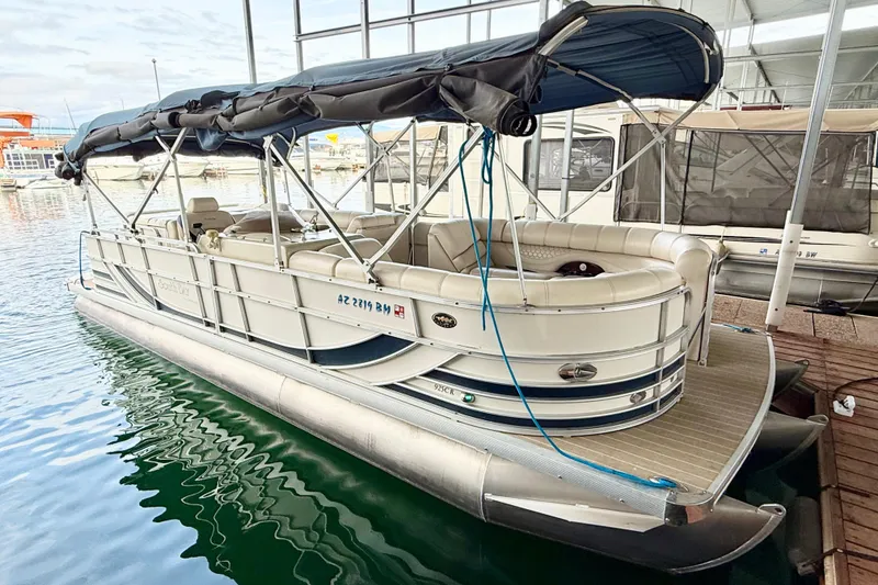 Slide: The Image of 2007 South Bay 925CR TT I/O pontoon boat docked with canopy and seating. - 5
