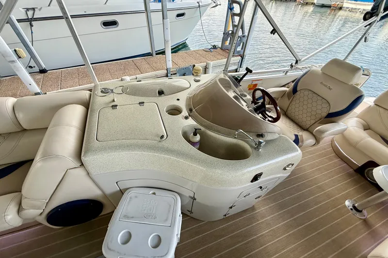 Slide: The Image of 2007 South Bay 925CR TT I/O boat interior with helm, seating, and controls. - 8