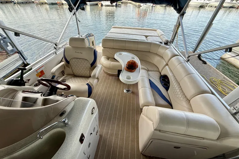Slide: The Image of Luxurious 2007 South Bay 925CR TT I/O pontoon boat interior with plush seating and steering console. - 9
