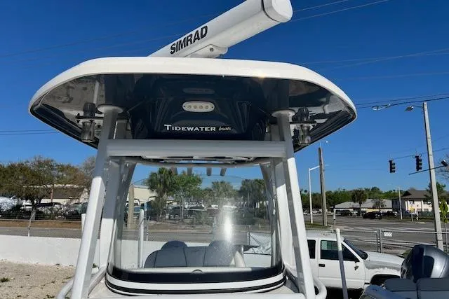 Slide: The Image of 2018 Tidewater 252 CC Adventure boat with Simrad radar, parked outdoors. - 12