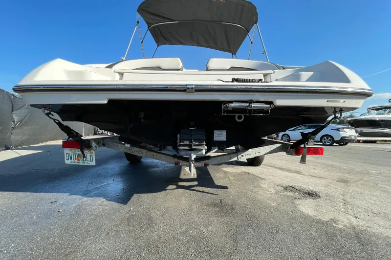 Slide: The Image of 2019 Yamaha Boats SX195 on display with sale banners under a cloudy sky. - 10