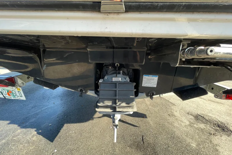 Slide: The Image of 2019 Yamaha Boats SX195 with canopy, displayed at a boat sale under a cloudy sky. - 11