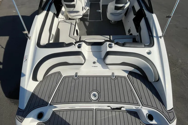 Slide: The Image of 2019 Yamaha Boats SX195 interior with sleek seating and modern dashboard. - 13
