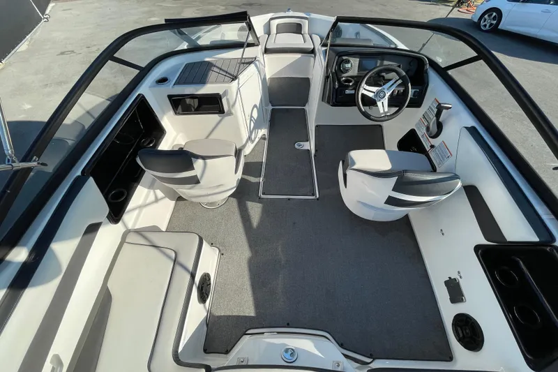 Slide: The Image of 2019 Yamaha Boats SX195 deck with storage compartment and safety instructions. - 17