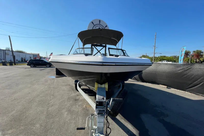 Slide: The Image of 2019 Yamaha Boats SX195 with swim platform and ladder, showcased at a boat sale. - 3