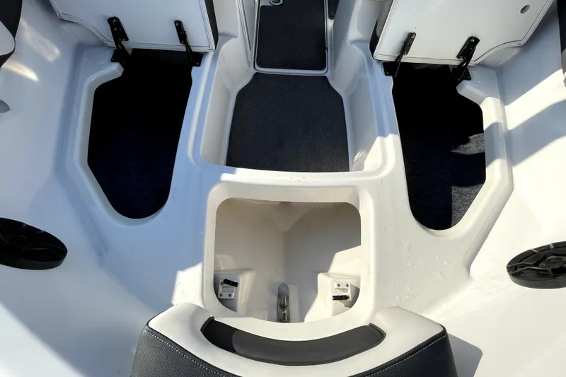 Slide: The Image of 2019 Yamaha Boats SX195 interior with gray carpet and seating. - 33
