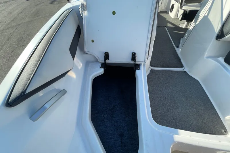 Slide: The Image of 2019 Yamaha Boats SX195 interior storage compartment with open hatch and seating. - 34