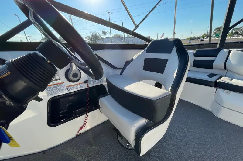 Slide: The Image of 2019 Yamaha Boats SX195 interior storage compartment with handle and carpeted flooring. - 38