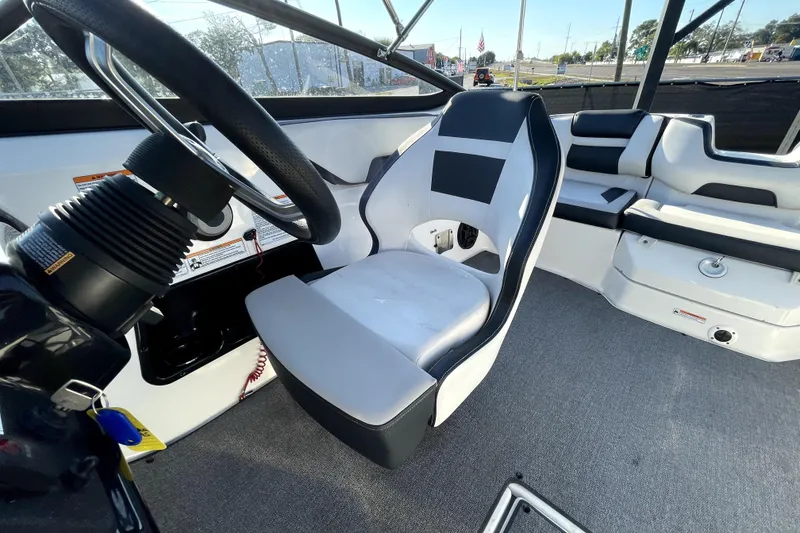 Slide: The Image of 2019 Yamaha Boats SX195 interior storage compartment with open door, showcasing spacious design. - 39