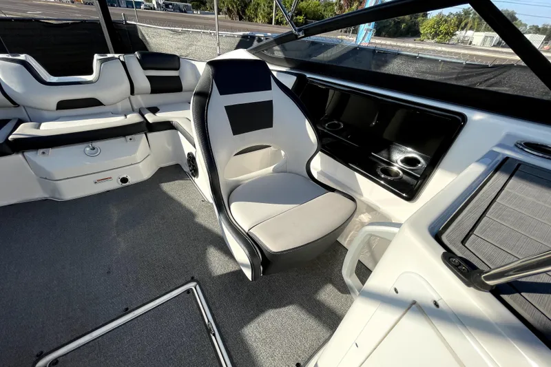Slide: The Image of 2019 Yamaha Boats SX195 storage compartment with carpeted interior and removable panel. - 40