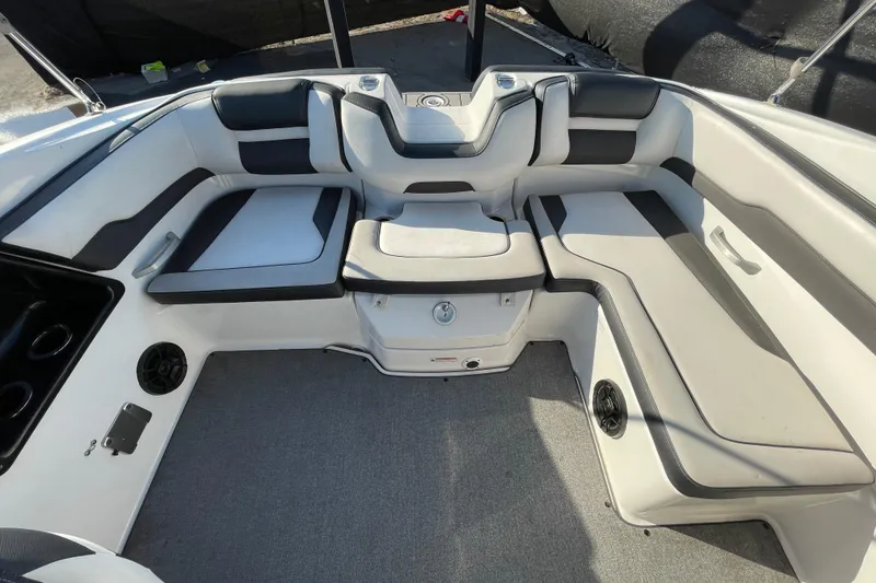 Slide: The Image of 2019 Yamaha Boats SX195 storage compartment with open door, showcasing interior space. - 42