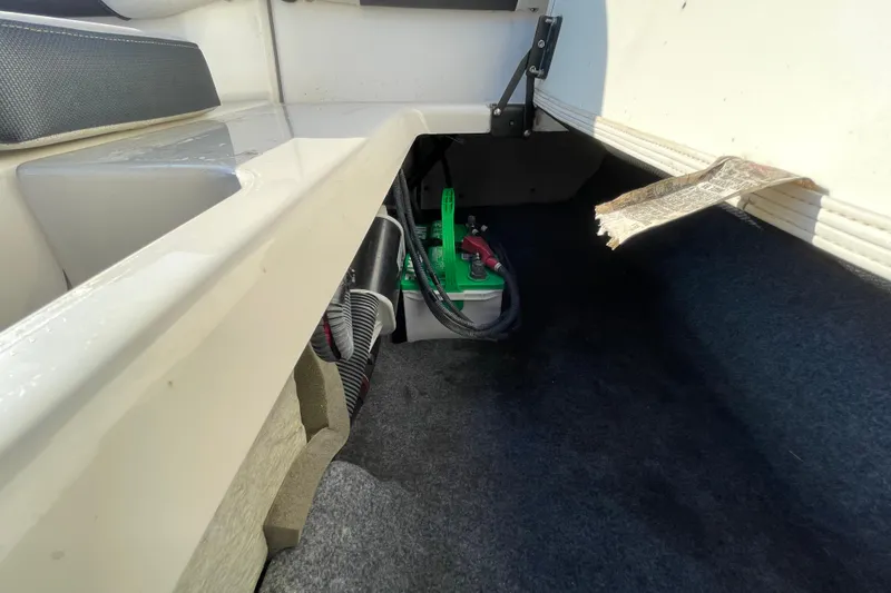 Slide: The Image of 2019 Yamaha Boats SX195 storage compartment interior, white and clean. - 50