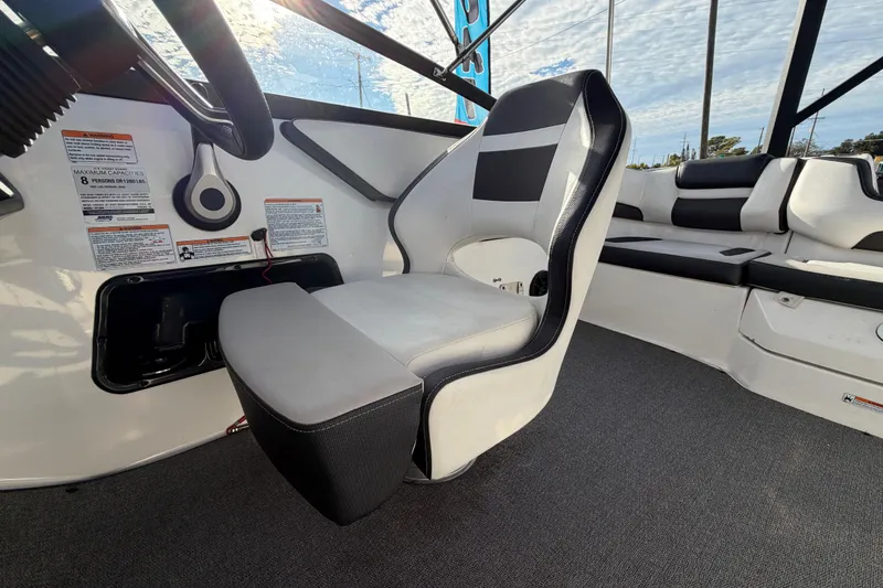 Slide: The Image of 2019 Yamaha Boats SX195 interior with captain's chair and passenger seating. - 65