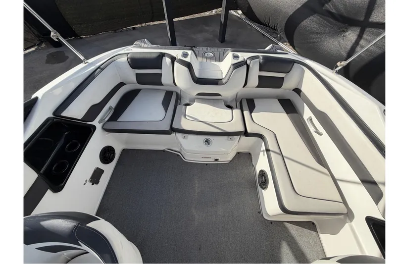 Slide: The Image of 2019 Yamaha Boats SX195 interior with cushioned seating and cup holders. - 67