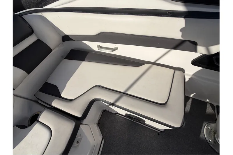 Slide: The Image of 2019 Yamaha Boats SX195 interior seating with white and black upholstery. - 69