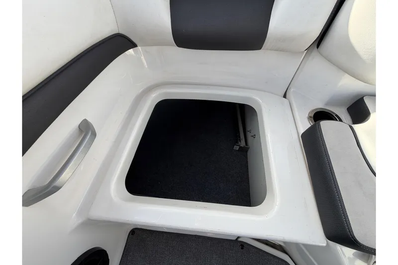 Slide: The Image of 2019 Yamaha Boats SX195 interior storage compartment with handle and seating area. - 73