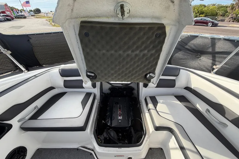 Slide: The Image of 2019 Yamaha Boats SX195 interior with open engine compartment, showcasing seating and engine details. - 75