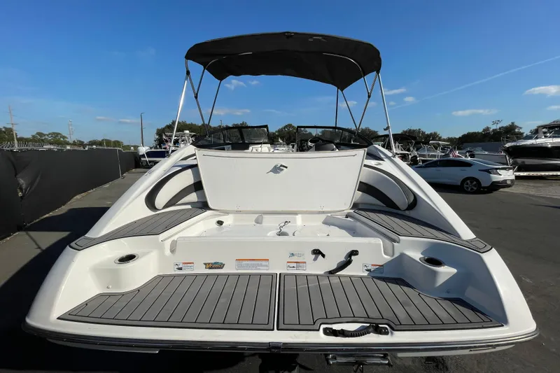 Slide: The Image of 2019 Yamaha Boats SX195 on trailer under cloudy sky, Florida registration visible. - 8