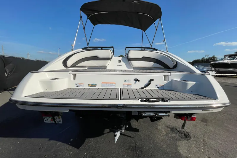 Slide: The Image of 2019 Yamaha Boats SX195 on trailer under cloudy sky. - 9