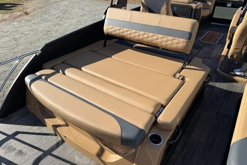 Slide: The Image of 2026 Godfrey Monaco 235 SFLC iMPACT boat with luxurious tan seating and cup holders. - 27