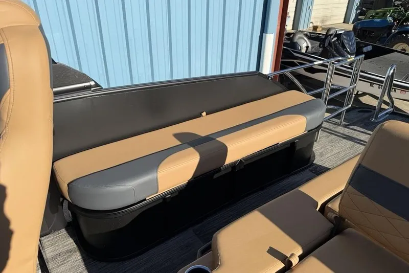 Slide: The Image of 2026 Godfrey Monaco 235 SFLC iMPACT boat seating, tan and gray upholstery, outdoor setting. - 29