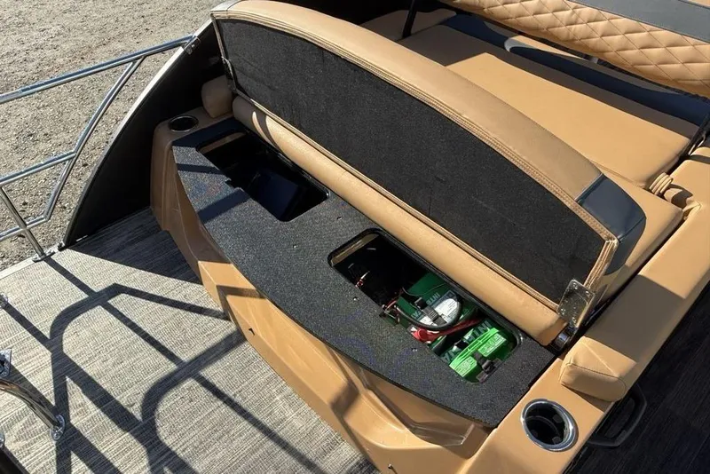 Slide: The Image of 2026 Godfrey Monaco 235 SFLC iMPACT boat with open storage compartment and tan seating. - 33