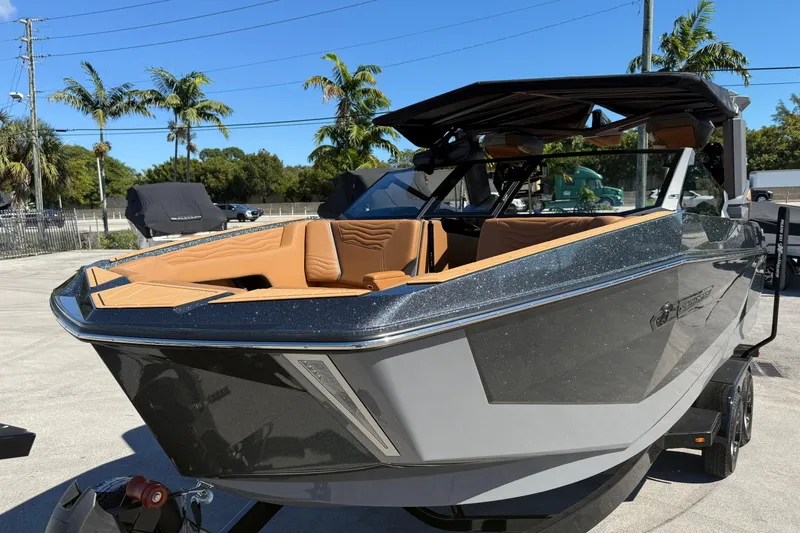Slide: The Image of 2026 Nautique Super Air Nautique G25 Coastal Edition boat on trailer, side view. - 4