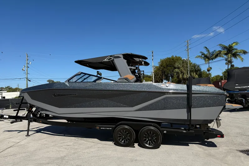Slide: The Image of 2026 Nautique Super Air Nautique G25 Coastal Edition boat interior with tan seating and sleek design. - 5