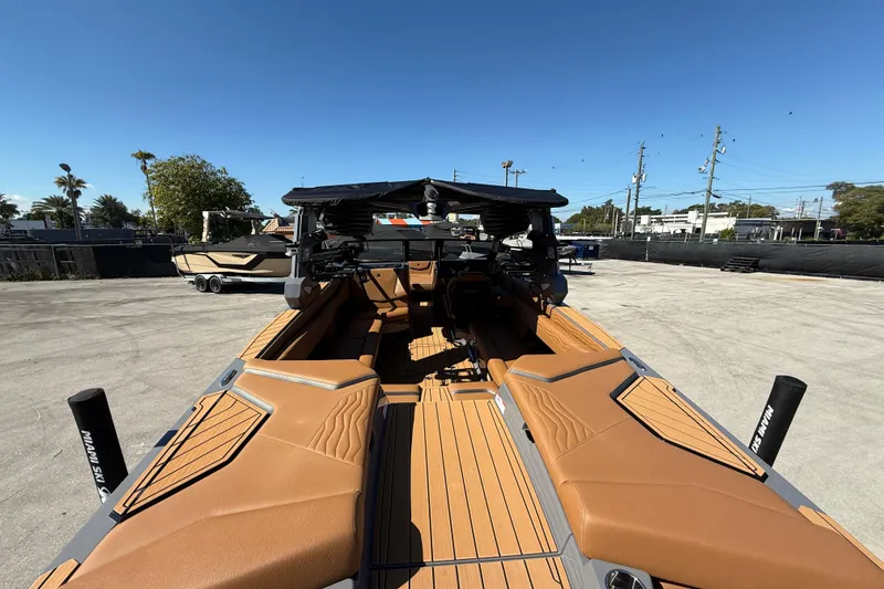 Slide: The Image of 2026 Nautique Super Air Nautique G25 Coastal Edition interior with luxurious tan seating. - 6