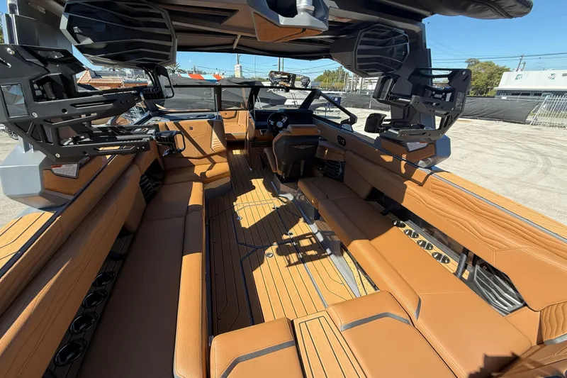 Slide: The Image of 2026 Nautique Super Air Nautique G25 Coastal Edition interior with tan seating and sleek design. - 7