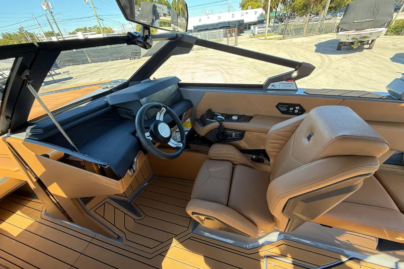 Slide: The Image of Interior of 2026 Nautique Super Air Nautique G25 Coastal Edition, featuring luxurious tan seating. - 9