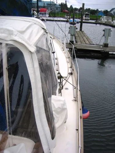 Slide: The Image of 1974 Hallberg-Rassy Rasmus 35 sailboat docked in harbor. - 44