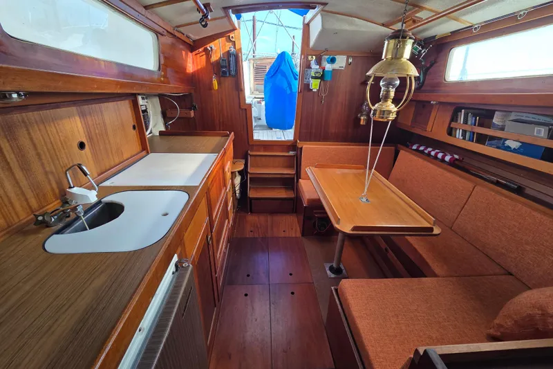 Slide: The Image of Interior of a 1974 Hallberg-Rassy Rasmus 35 sailboat with wood finish and cozy seating. - 7