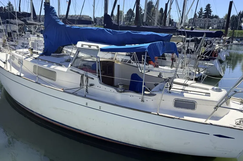 Slide: The Image of 1974 Hallberg-Rassy Rasmus 35 sailboat docked in a marina, covered with blue tarps. - 80