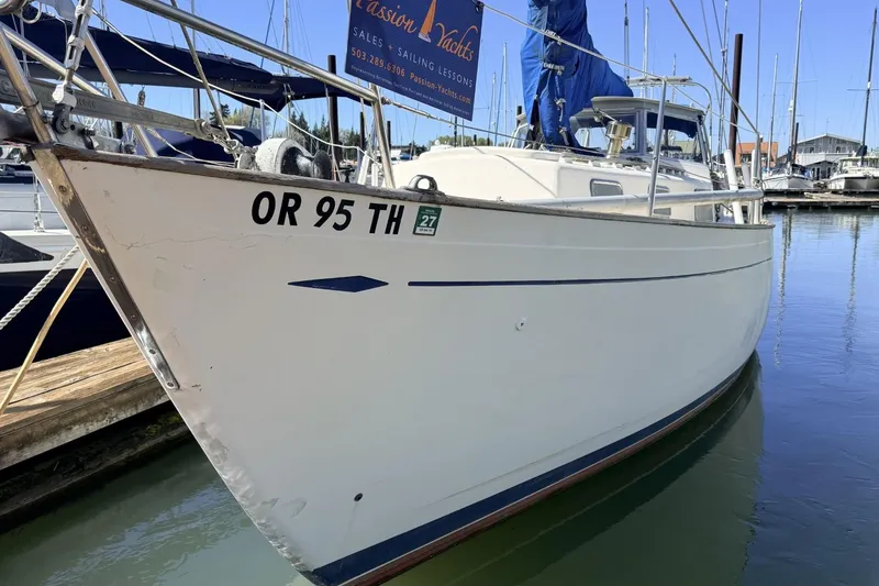 Slide: The Image of 1974 Hallberg-Rassy Rasmus 35 sailboat docked in marina, showcasing sleek design and craftsmanship. - 81