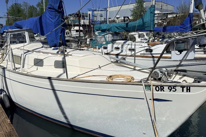 Slide: The Image of 1974 Hallberg-Rassy Rasmus 35 sailboat docked in a marina, featuring a classic design. - 83