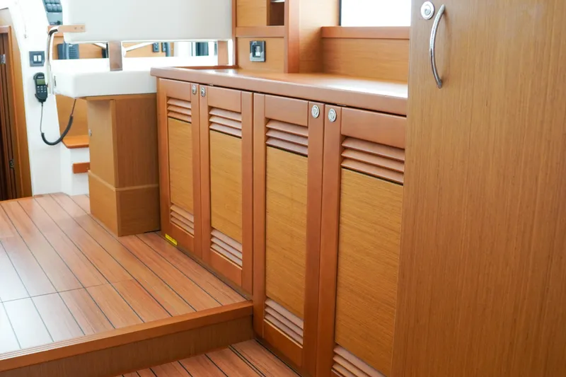 Slide: The Image of 2023 Beneteau Swift Trawler 41 Fly interior with wooden cabinetry and flooring. - 5