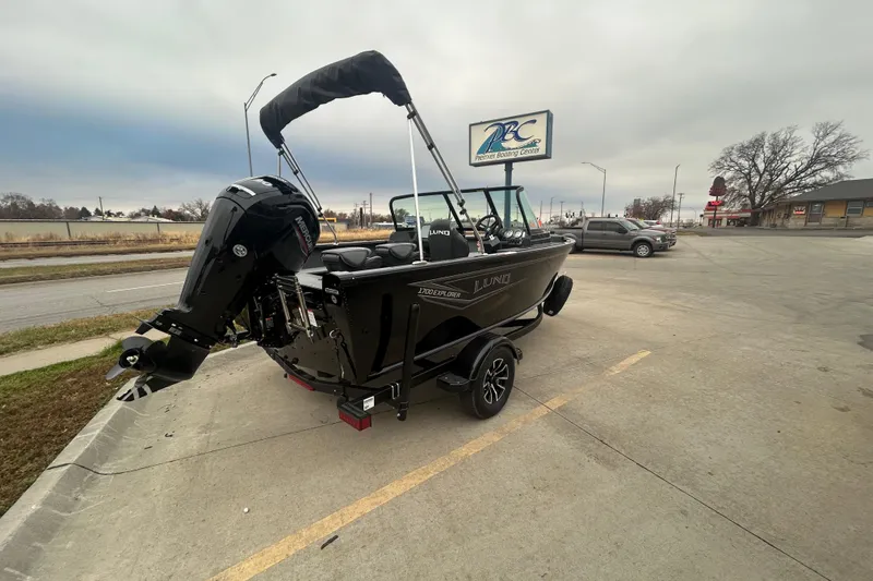 Slide: The Image of 2026 Lund 1700 Explorer Sport boat on trailer at dealership parking lot. - 13