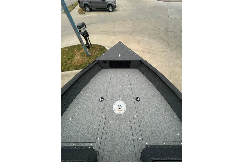 Slide: The Image of 2026 Lund 1700 Explorer Sport boat deck, gray finish, parked outdoors. - 14