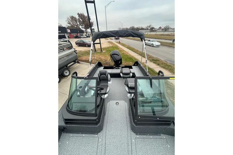 Slide: The Image of 2026 Lund 1700 Explorer Sport boat with dual windshields and seating, parked outdoors. - 15