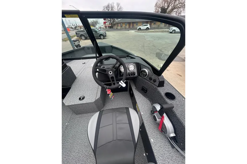 Slide: The Image of Interior view of 2026 Lund 1700 Explorer Sport boat, featuring steering wheel and dashboard controls. - 18