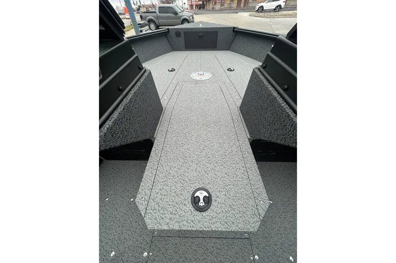 Slide: The Image of 2026 Lund 1700 Explorer Sport boat interior with gray textured flooring. - 21